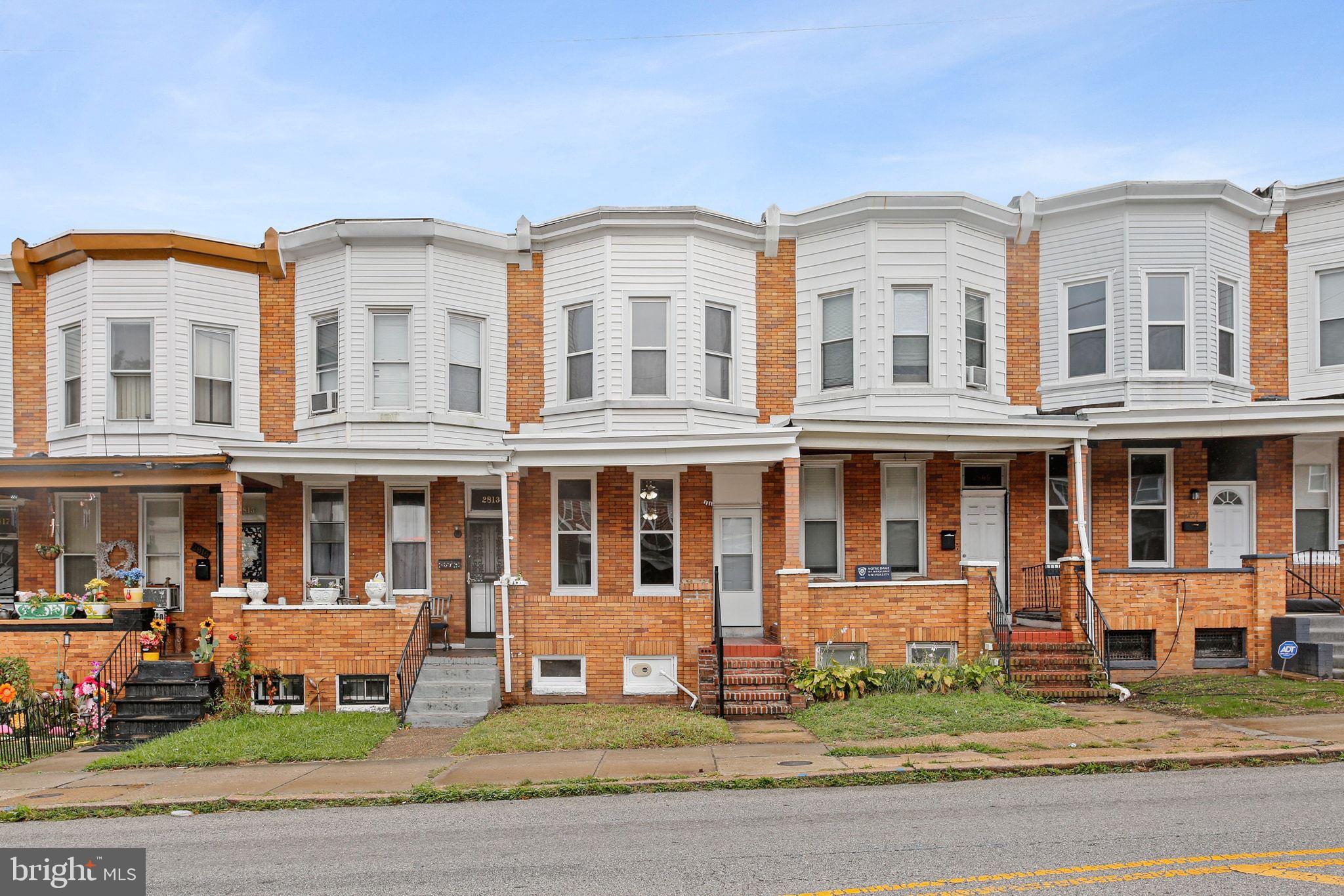 2811 Erdman Avenue Baltimore, MD 21213 - Photo 2 of 31 a view of a brick building next to a yard