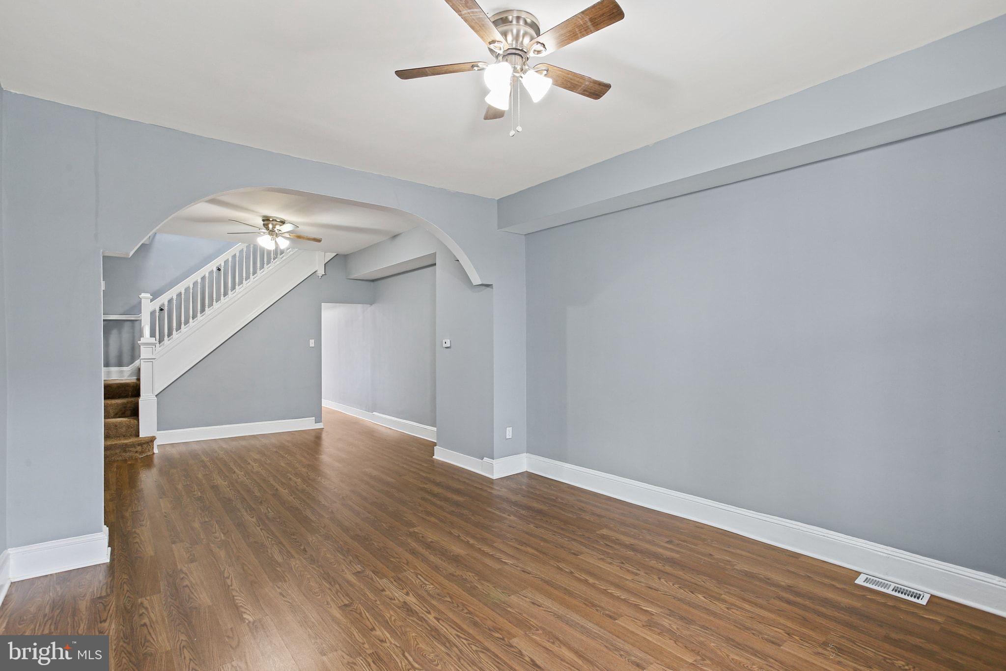 2811 Erdman Avenue Baltimore, MD 21213 - Photo 4 of 31 wooden floor in an empty room with a window