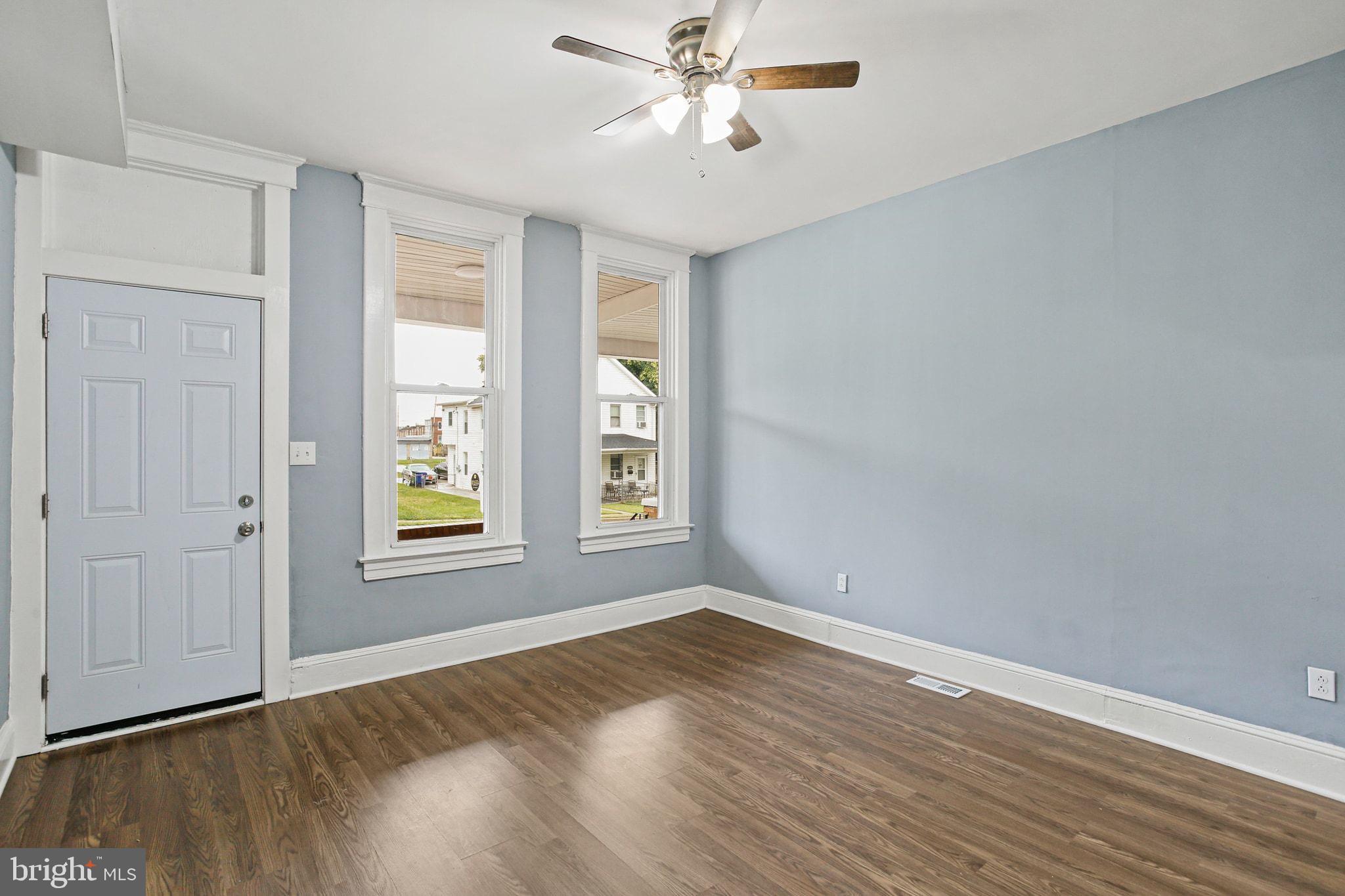 2811 Erdman Avenue Baltimore, MD 21213 - Photo 6 of 31 wooden floor in an empty room with a window