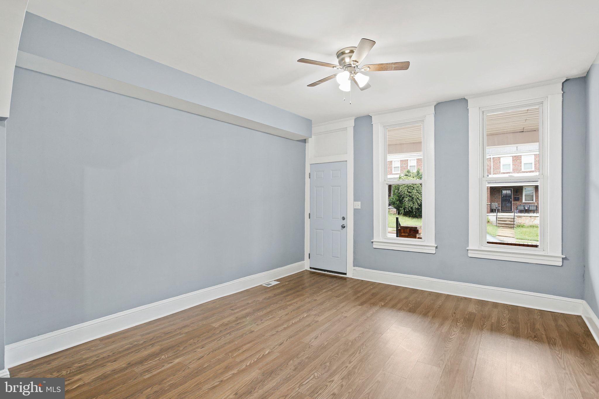 2811 Erdman Avenue Baltimore, MD 21213 - Photo 7 of 31 a view of an empty room with a window and wooden floor