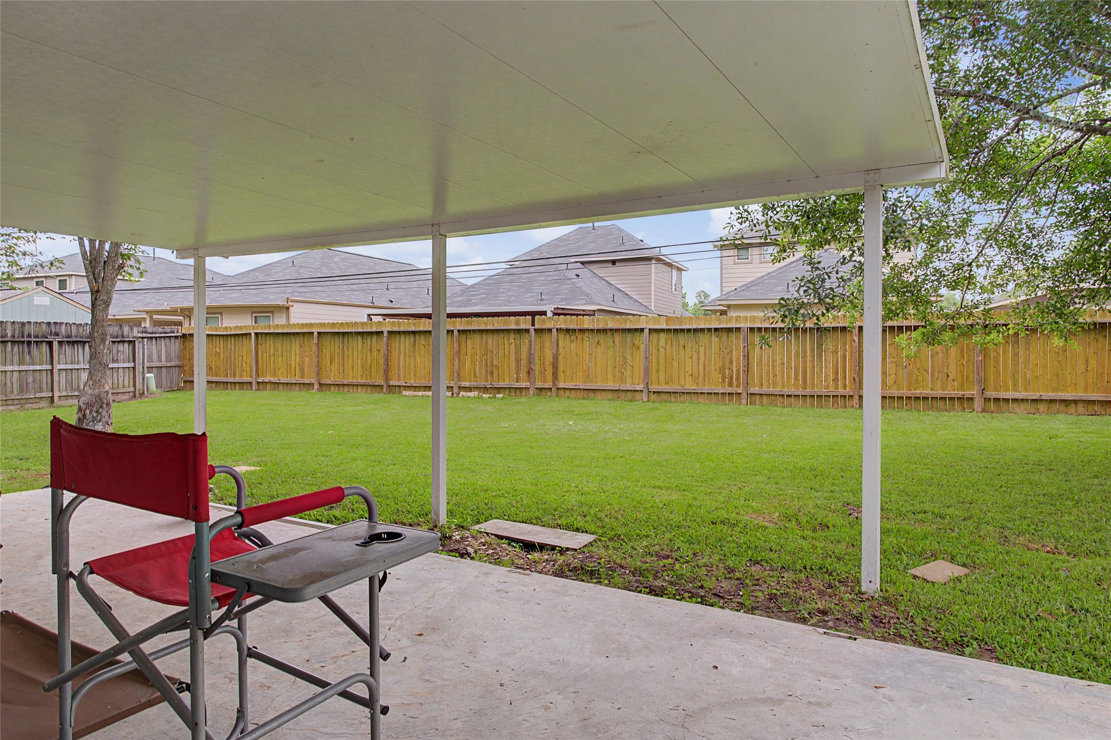 327 Fir Ridge Drive Huffman, TX 77336 - Photo 20 of 25 Large Covered patio. Back fence was replaced in 2023.