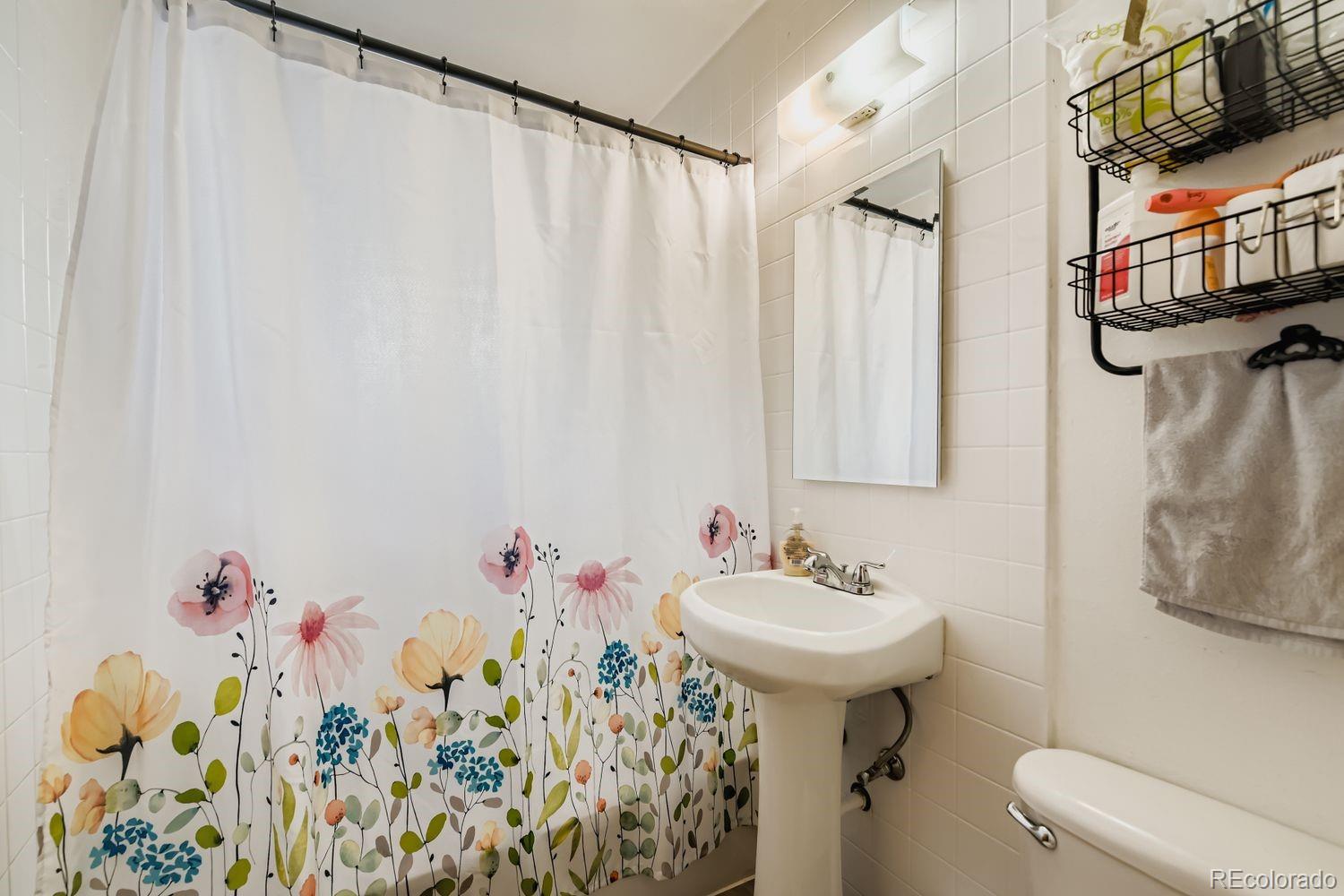 315 6th Street Fort Lupton, CO 80621 - Photo 13 of 26 a bathroom with a sink toilet and a mirror