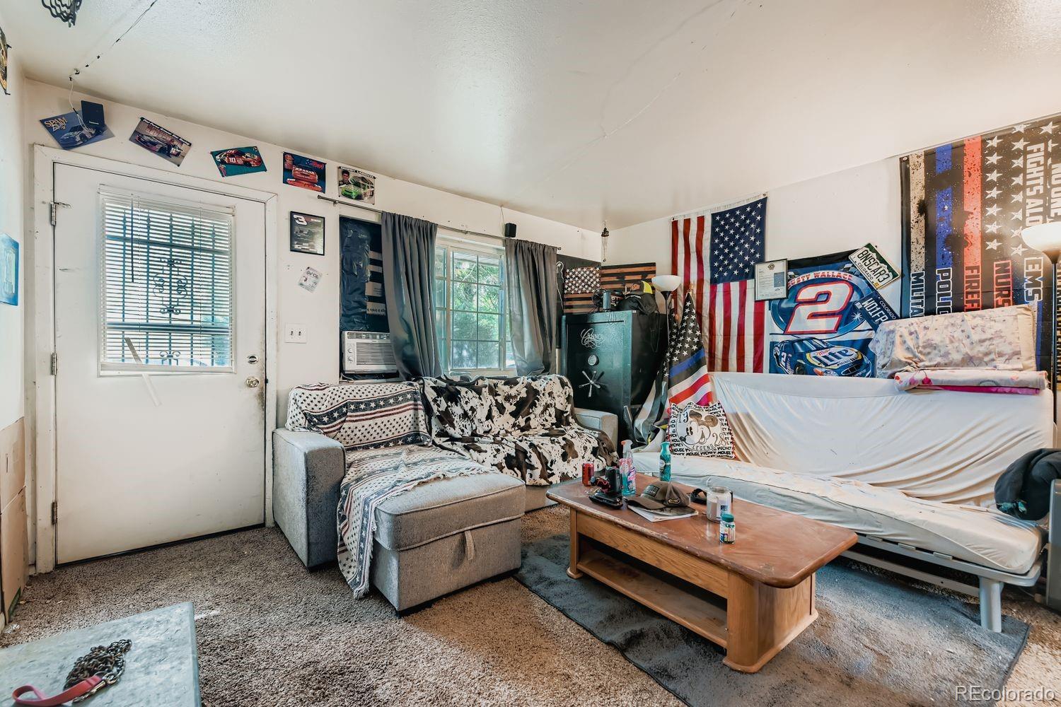 315 6th Street Fort Lupton, CO 80621 - Photo 15 of 26 a living room with furniture and a flat screen tv