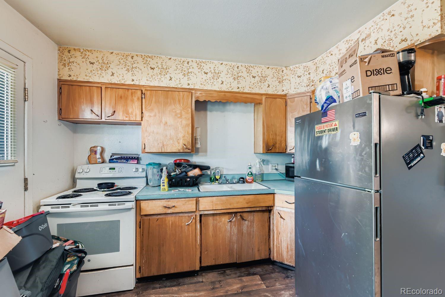 315 6th Street Fort Lupton, CO 80621 - Photo 16 of 26 a kitchen with white cabinets and white appliances