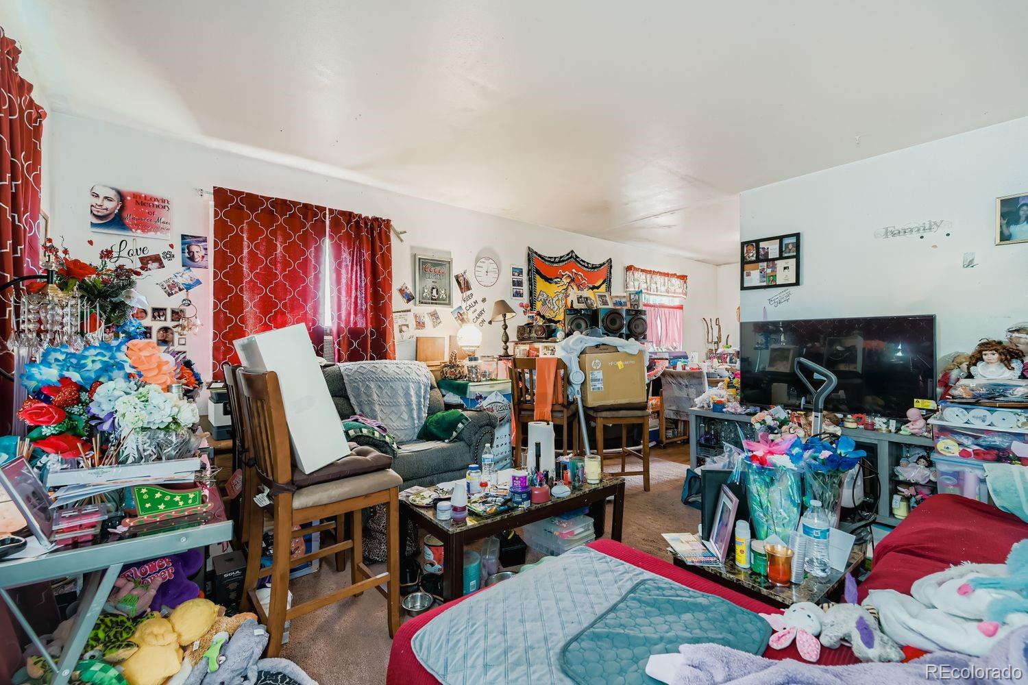 315 6th Street Fort Lupton, CO 80621 - Photo 21 of 26 a room with furniture and a flat screen tv