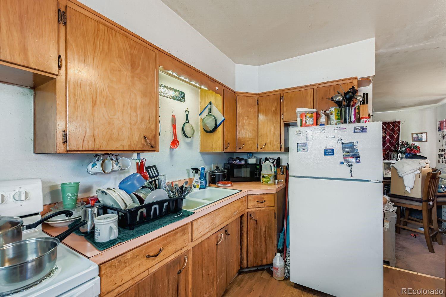 315 6th Street Fort Lupton, CO 80621 - Photo 23 of 26 a kitchen with stainless steel appliances a stove a refrigerator sink and cabinets