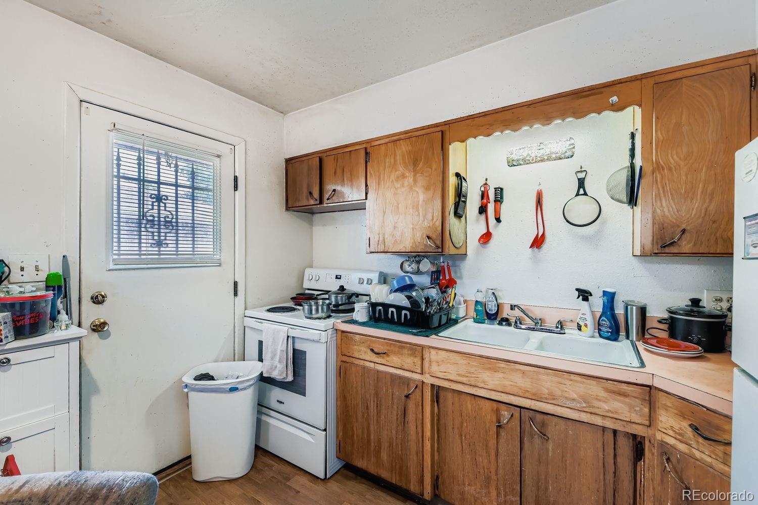 315 6th Street Fort Lupton, CO 80621 - Photo 24 of 26 a kitchen with a sink stove and cabinets