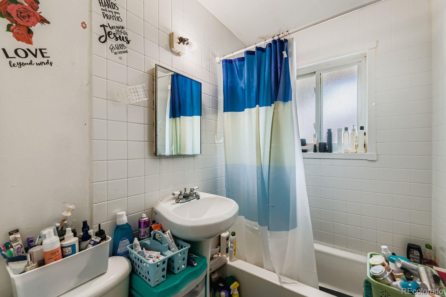 315 6th Street Fort Lupton, CO 80621 - Photo 26 of 26 a bathroom with a sink and a mirror
