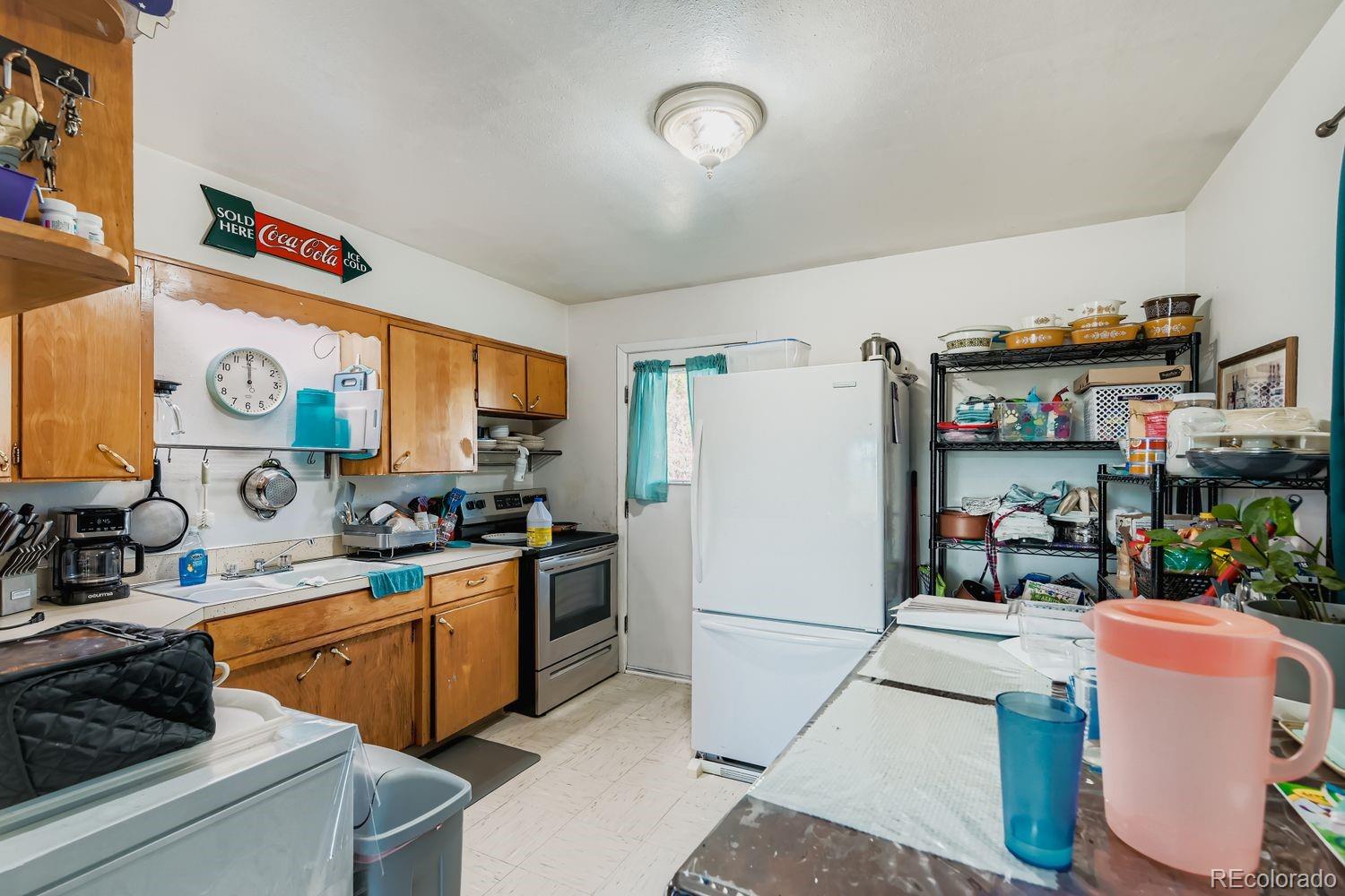 315 6th Street Fort Lupton, CO 80621 - Photo 10 of 26 a kitchen with stainless steel appliances granite countertop a refrigerator and a stove top oven