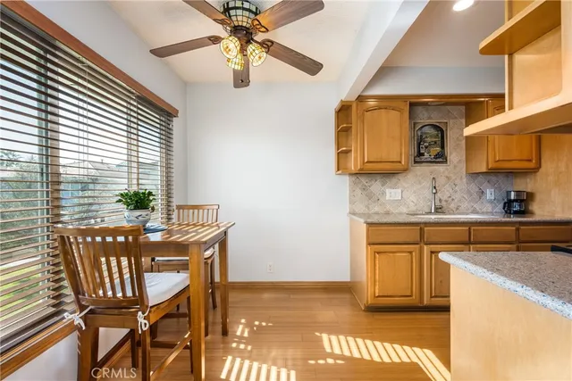 a view of a kitchen area with furniture and wooden floor