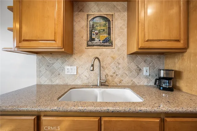 a kitchen with granite countertop a sink and cabinets