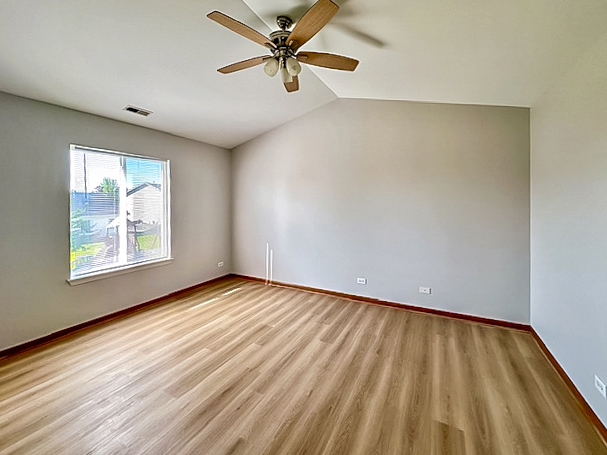 637 Deames Street Plano, IL 60545 - Photo 11 of 18 wooden floor in an empty room with a window
