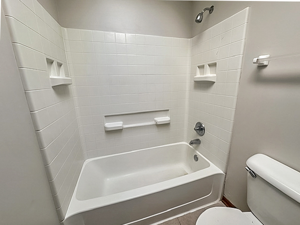 637 Deames Street Plano, IL 60545 - Photo 14 of 18 a white bath tub sitting next to a white toilet