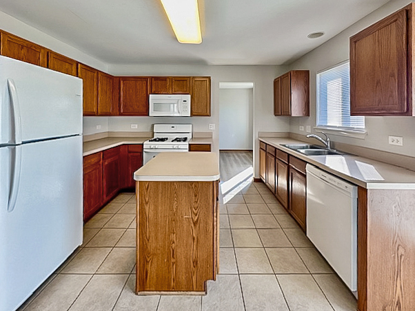 637 Deames Street Plano, IL 60545 - Photo 5 of 18 a kitchen with stainless steel appliances a refrigerator sink stove and cabinets