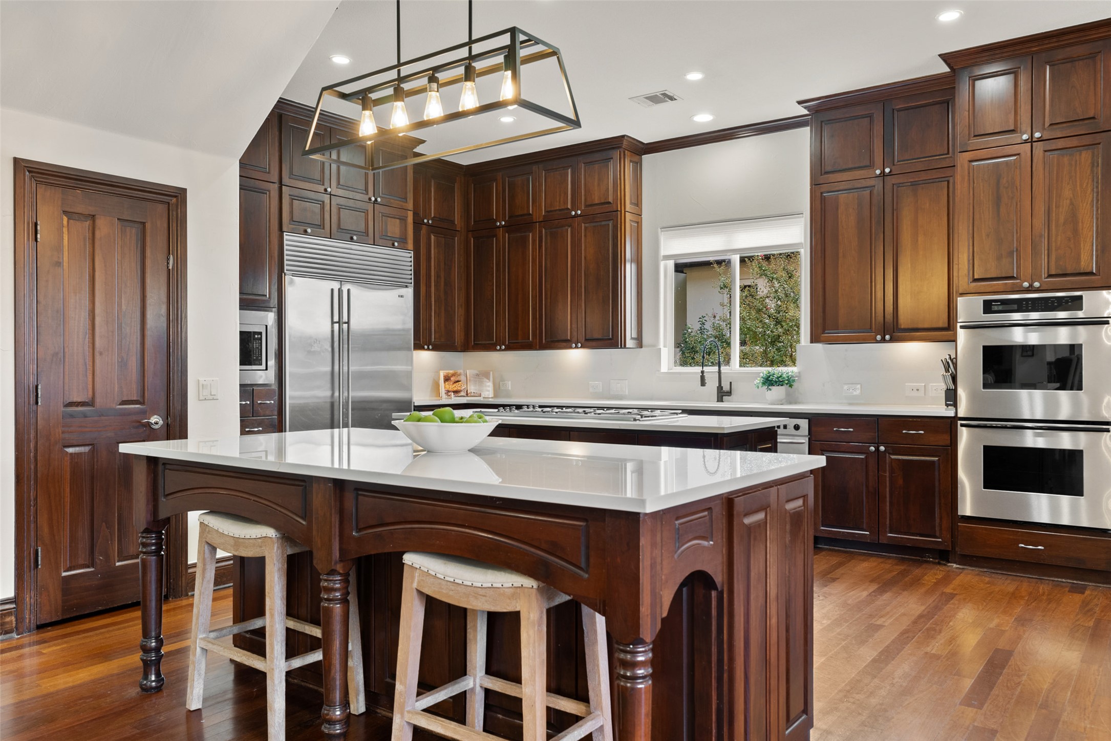 12027 Pleasant Panorama View Austin, TX 78738 - Photo 12 of 40 Warm custom cabinetry provides plenty of storage options. Double islands, means plenty of space to prepare for large gatherings