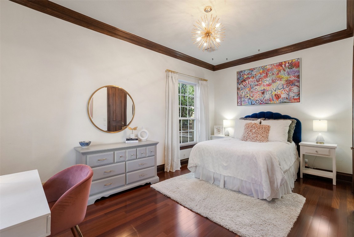 12027 Pleasant Panorama View Austin, TX 78738 - Photo 16 of 40 a bedroom with a large bed a chandelier with a dresser