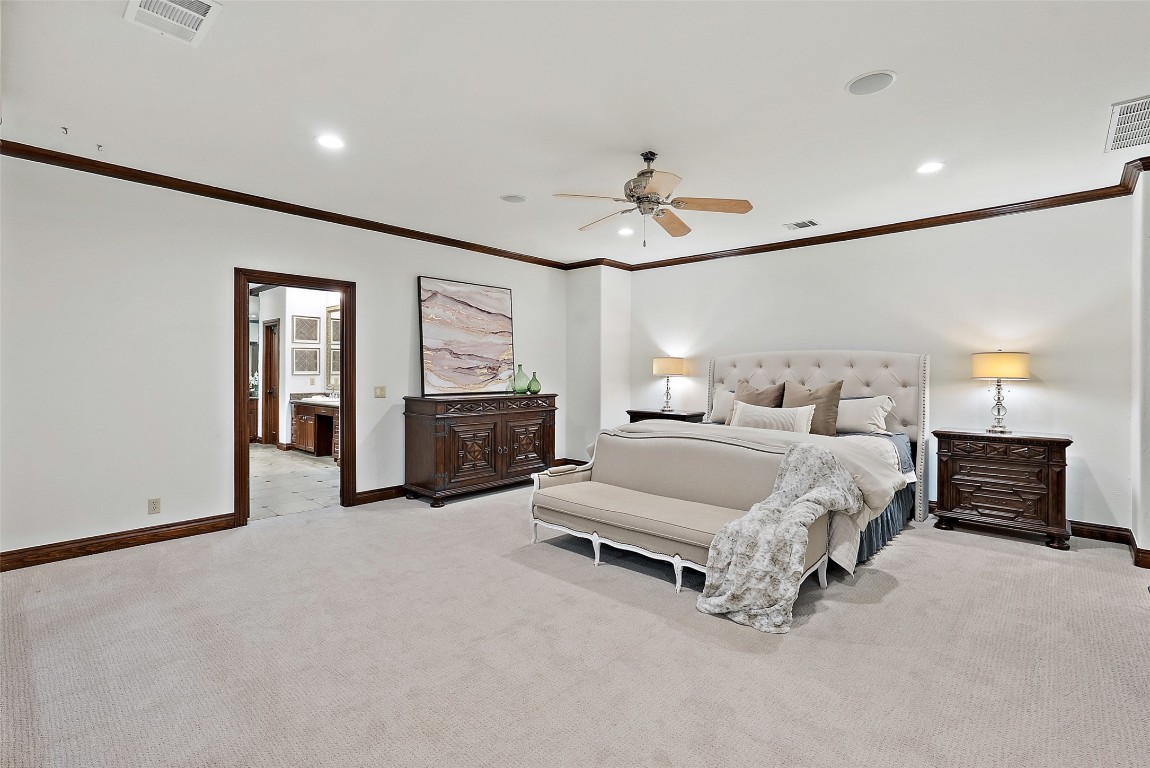 12027 Pleasant Panorama View Austin, TX 78738 - Photo 24 of 40 a spacious bedroom with a bed and ceiling fan