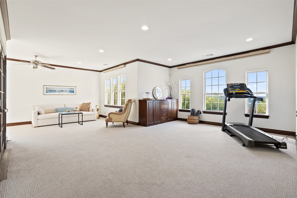 12027 Pleasant Panorama View Austin, TX 78738 - Photo 26 of 40 a view of a big room with gym equipment and a large window