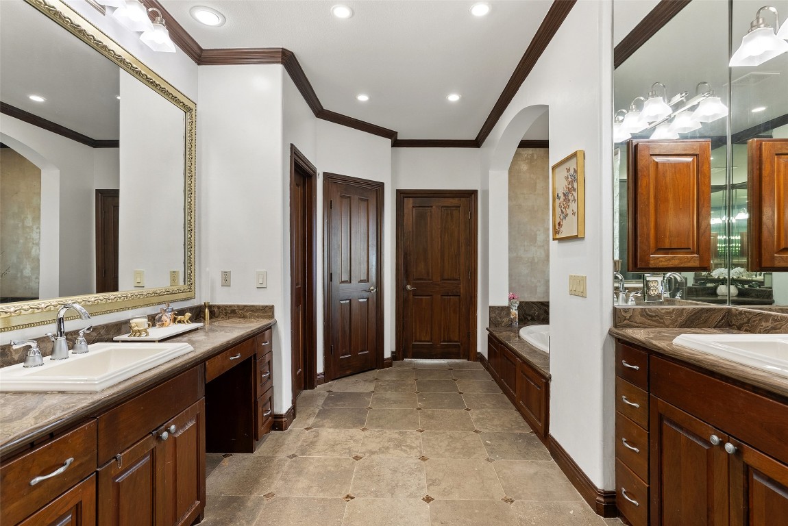 12027 Pleasant Panorama View Austin, TX 78738 - Photo 31 of 40 a spacious bathroom with a double vanity sink and a mirror