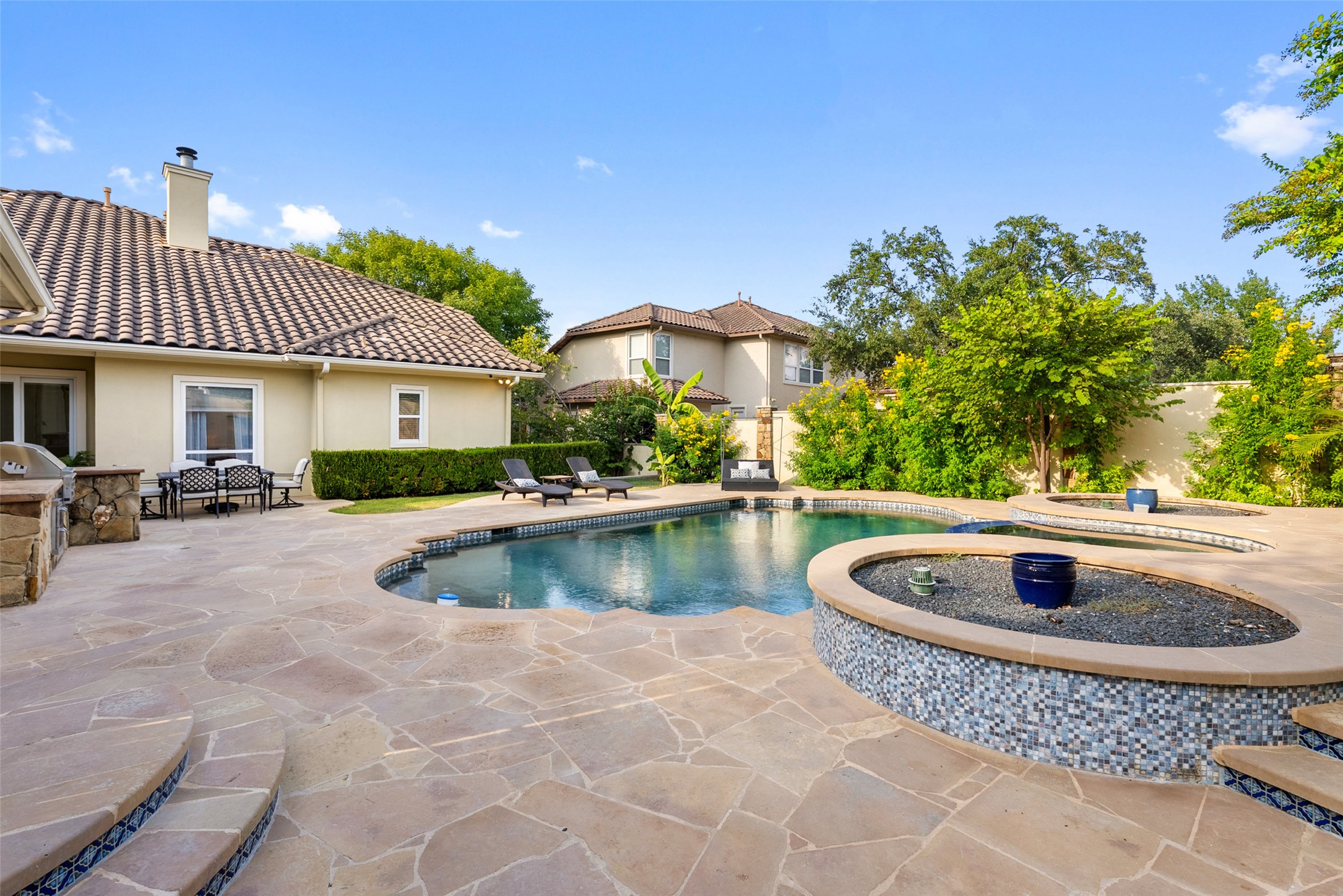 12027 Pleasant Panorama View Austin, TX 78738 - Photo 32 of 40 Pool, spa, and outdoor kitchen. Plenty of hardscape around the pool for entertaining
