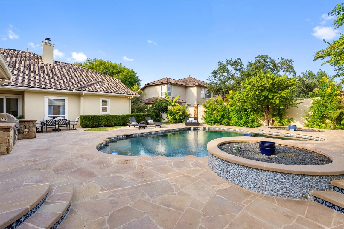12027 Pleasant Panorama View Austin, TX 78738 - Photo 32 of 40 a view of swimming pool with outdoor seating and plants
