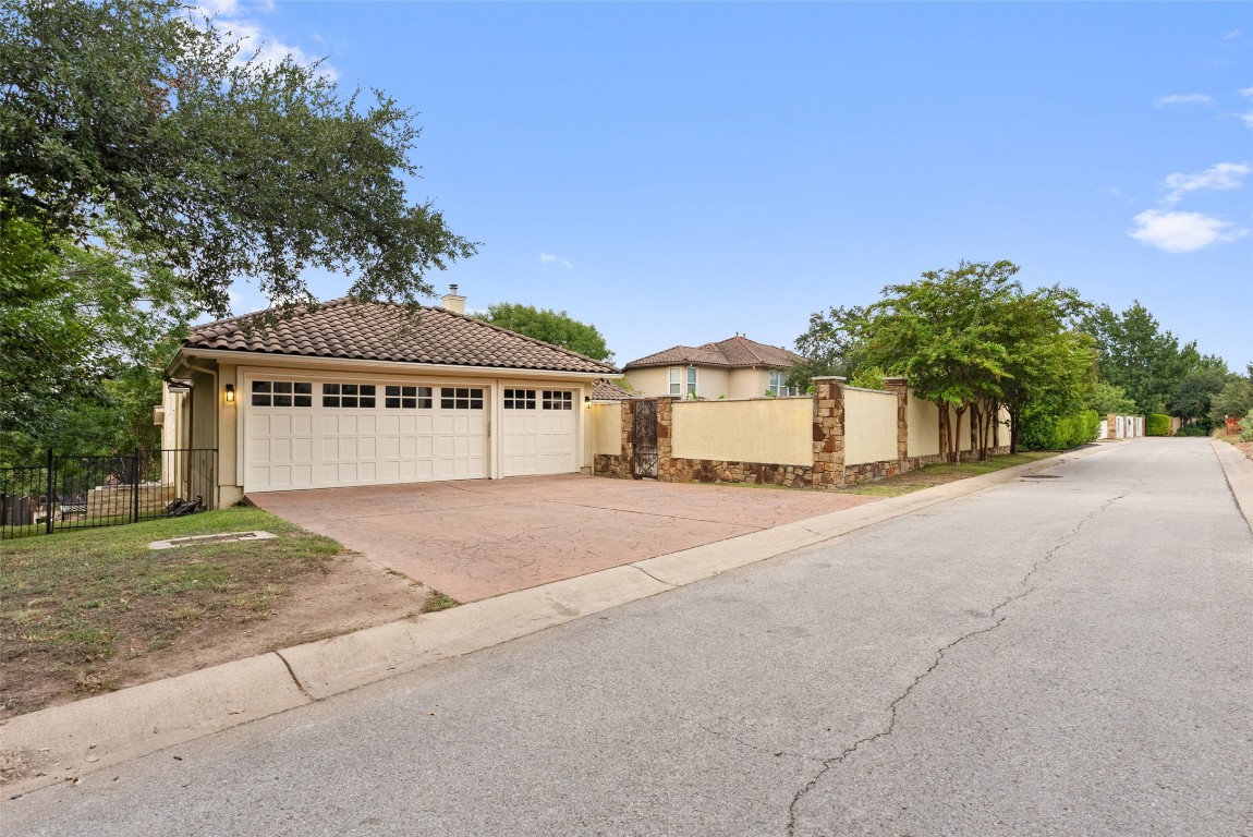 12027 Pleasant Panorama View Austin, TX 78738 - Photo 34 of 40 a front view of a house with a yard and garage
