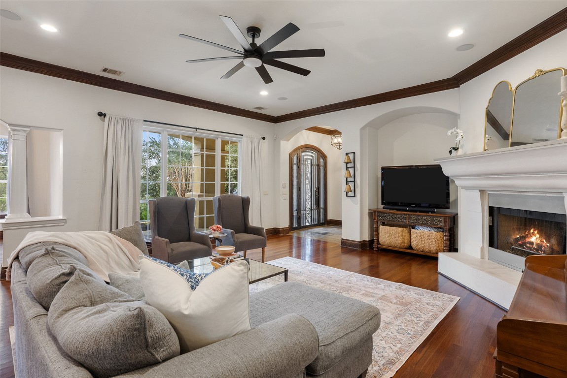 12027 Pleasant Panorama View Austin, TX 78738 - Photo 6 of 40 a living room with furniture fireplace and a flat screen tv