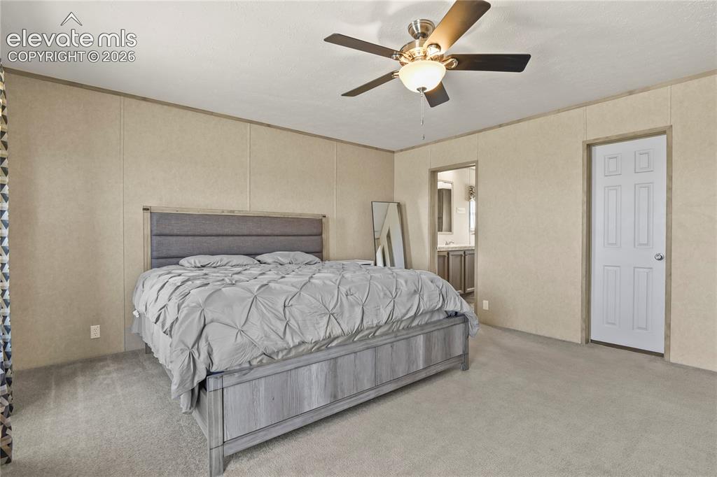22280 Jones Road Peyton, CO 80831 - Photo 16 of 47 a bedroom with a bed and a ceiling fan