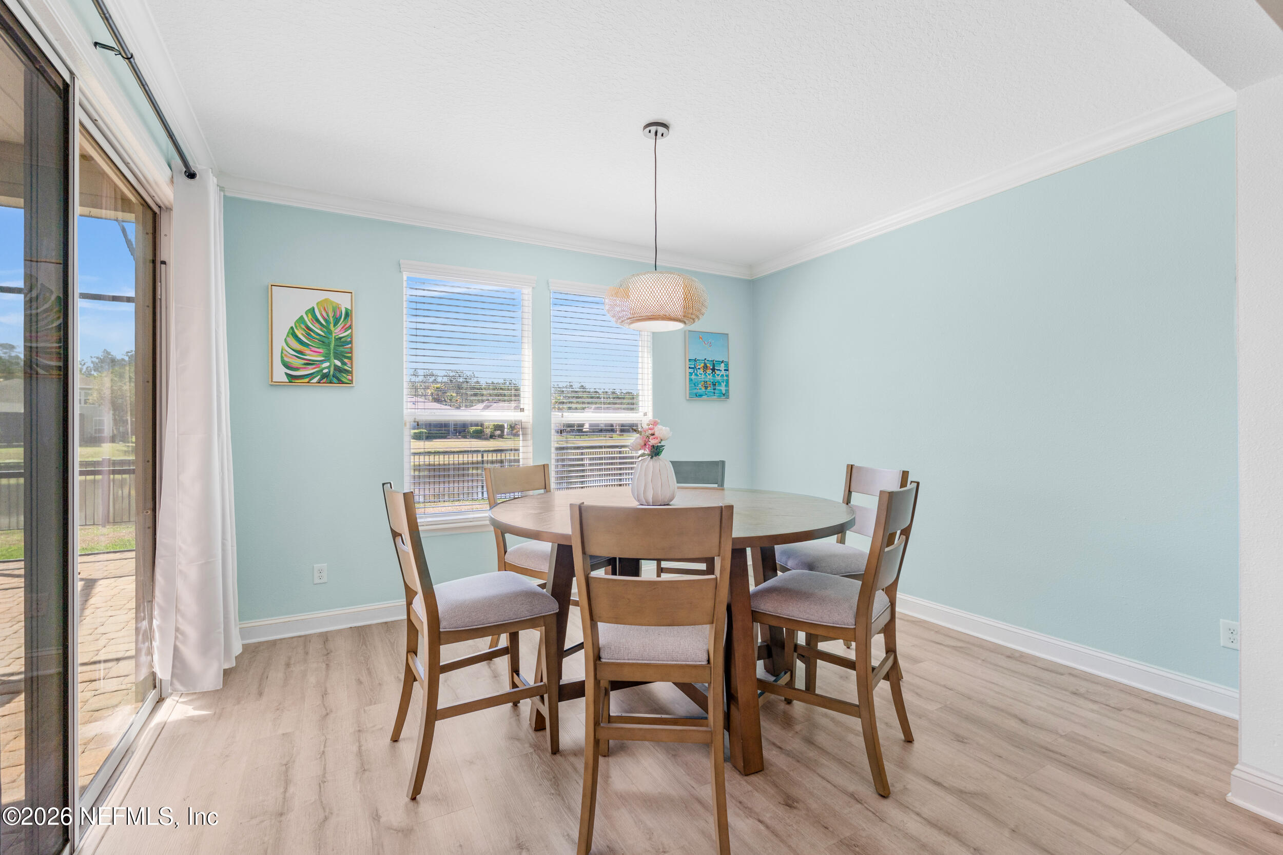 168 St Kitts Loop St. Augustine, FL 32092 - Photo 22 of 47 a dining room with furniture a chandelier and wooden floor