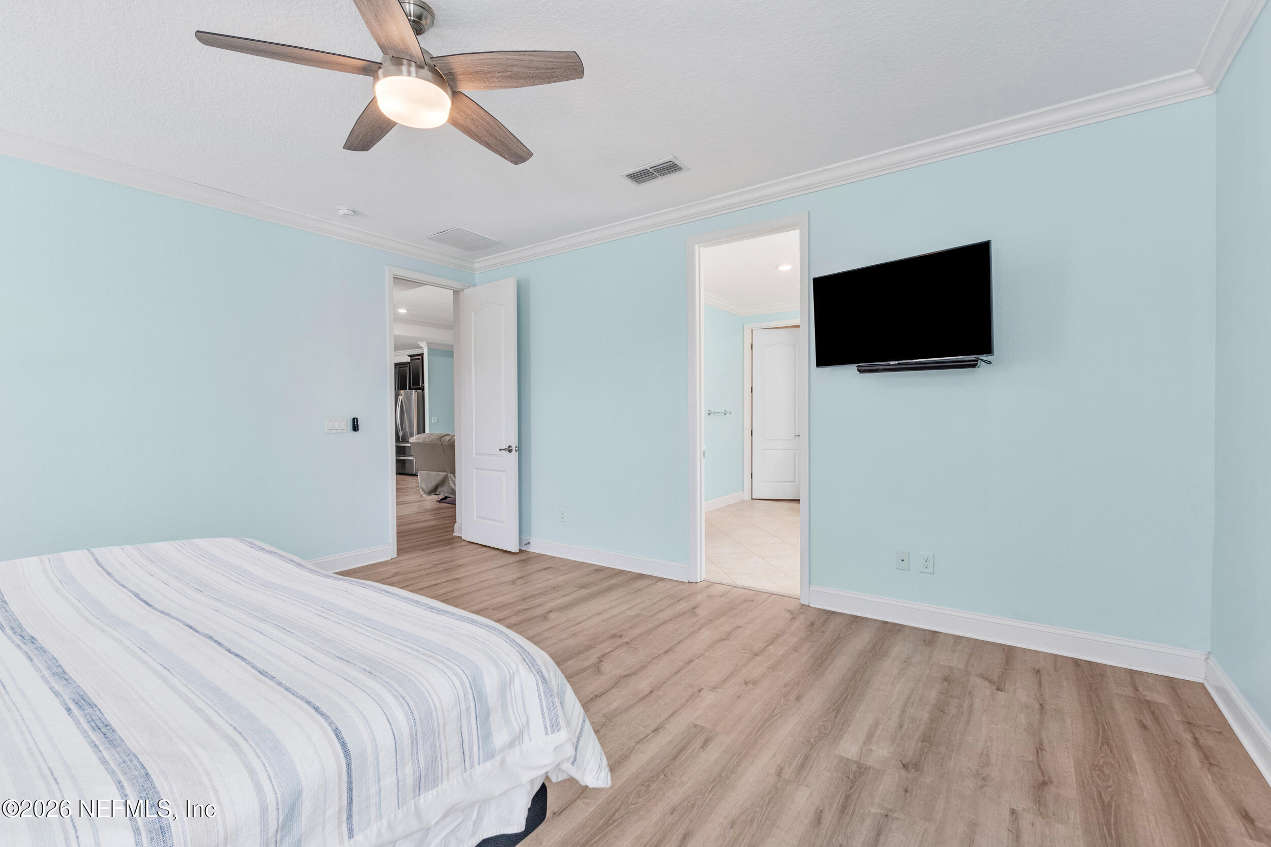 168 St Kitts Loop St. Augustine, FL 32092 - Photo 24 of 47 a bedroom with a bed and a flat screen tv