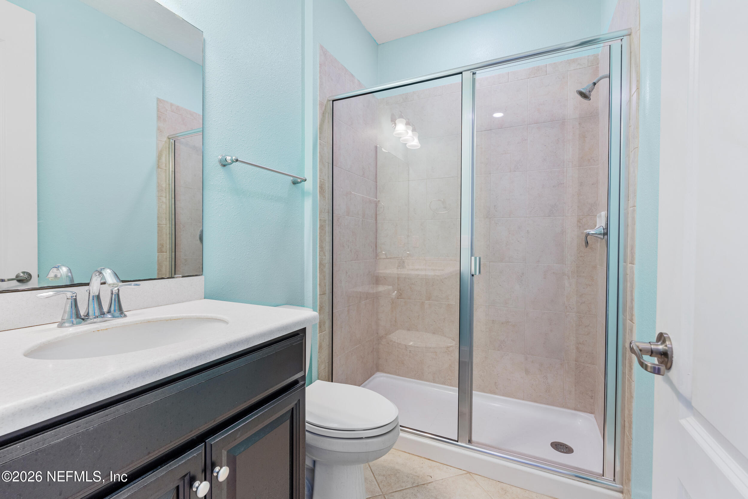 168 St Kitts Loop St. Augustine, FL 32092 - Photo 29 of 47 a bathroom with a shower sink vanity mirror and toilet
