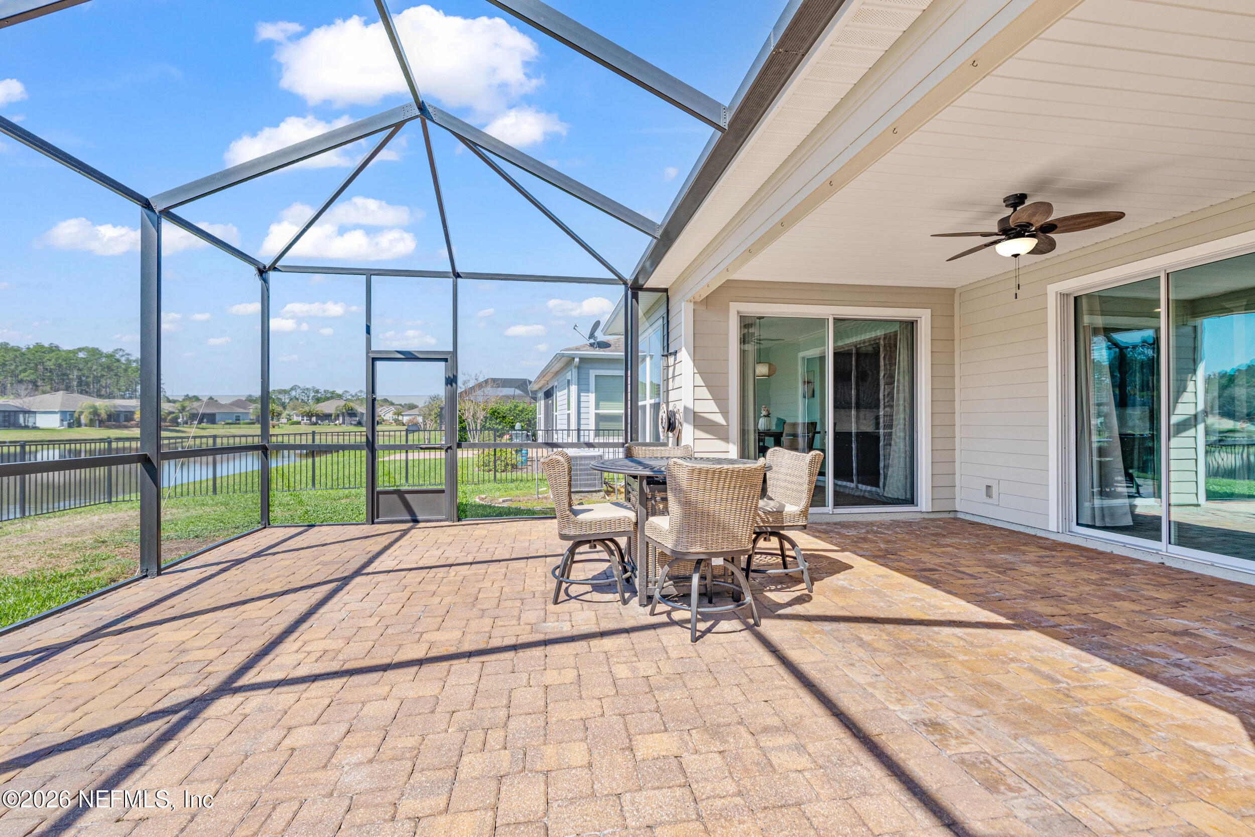 168 St Kitts Loop St. Augustine, FL 32092 - Photo 33 of 47 a view of a patio with a table and chairs under an umbrella