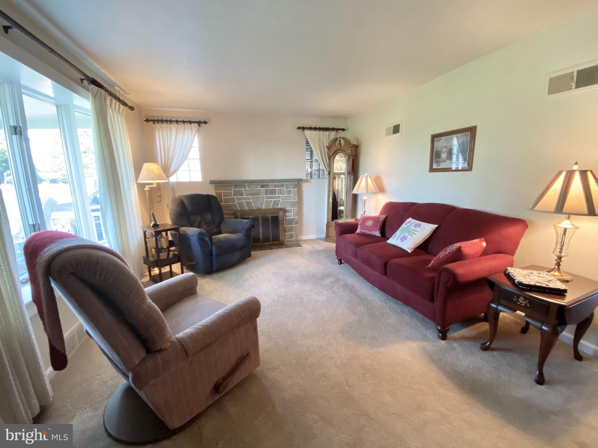 3738 Salem Road York, PA 17408 - Photo 4 of 27 LR with carpet over HW floor, gas FPL
