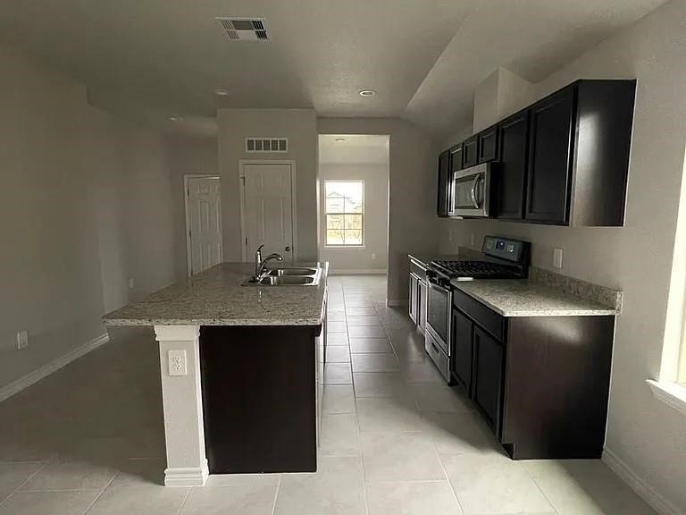2317 Restful Lane Corpus Christi, TX 78418 - Photo 2 of 6 a kitchen with stainless steel appliances granite countertop a refrigerator a stove and a sink