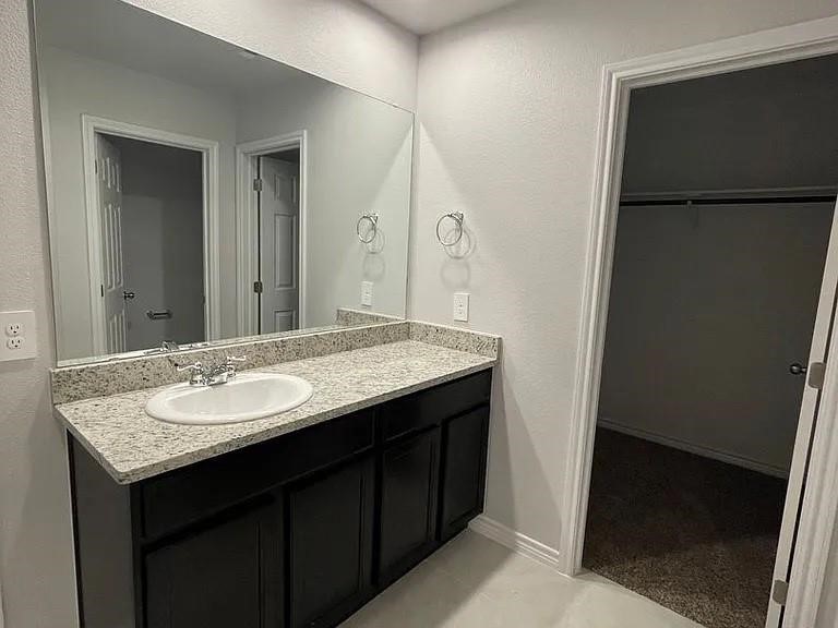 2317 Restful Lane Corpus Christi, TX 78418 - Photo 5 of 6 a bathroom with a granite countertop sink and a mirror
