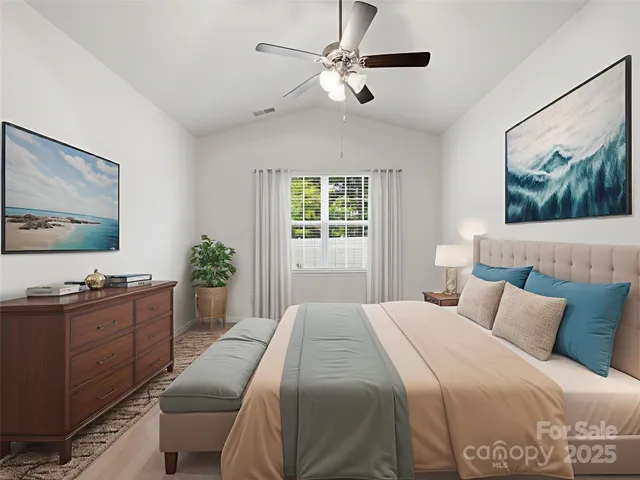 a bedroom with a large bed and a dresser