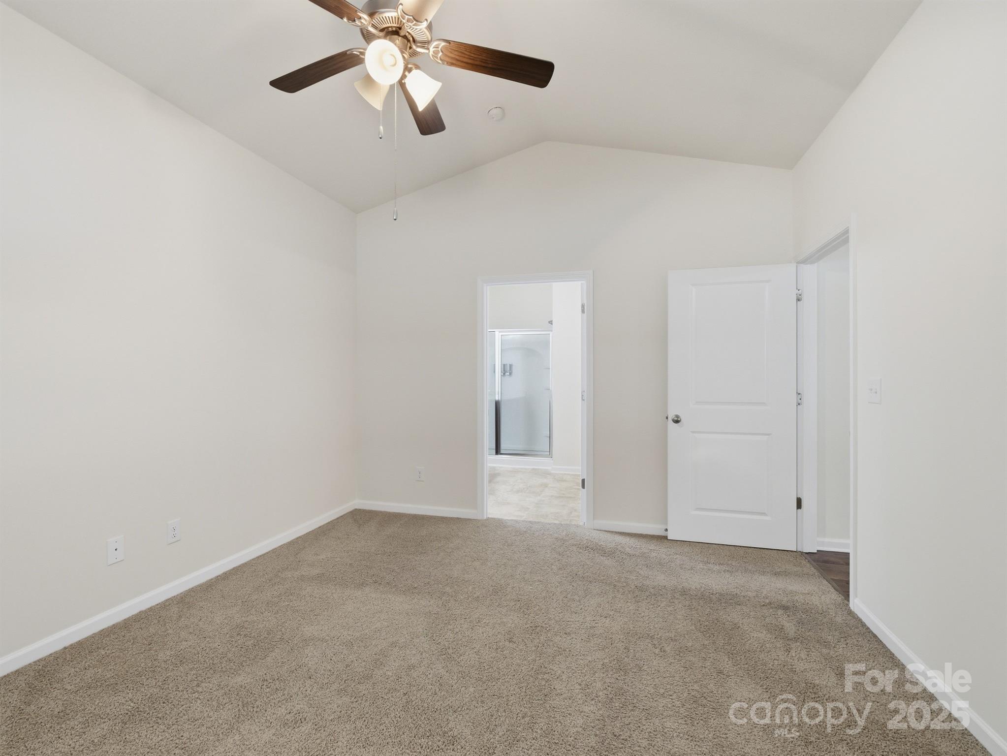2212 Apple Glen Lane Charlotte, NC 28269 - Photo 17 of 32 an empty room with chandelier fan and windows