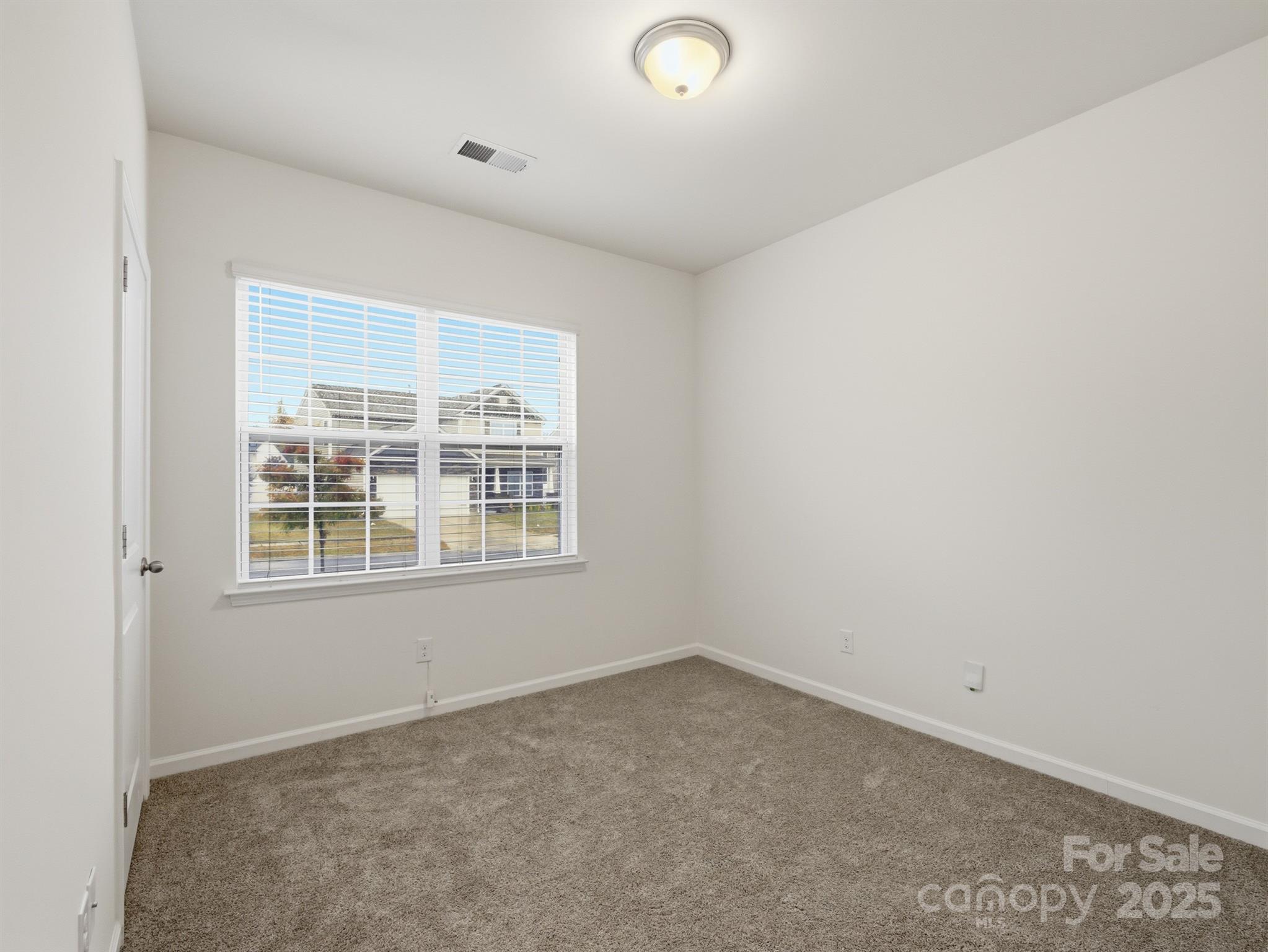 2212 Apple Glen Lane Charlotte, NC 28269 - Photo 20 of 32 an empty room with a window