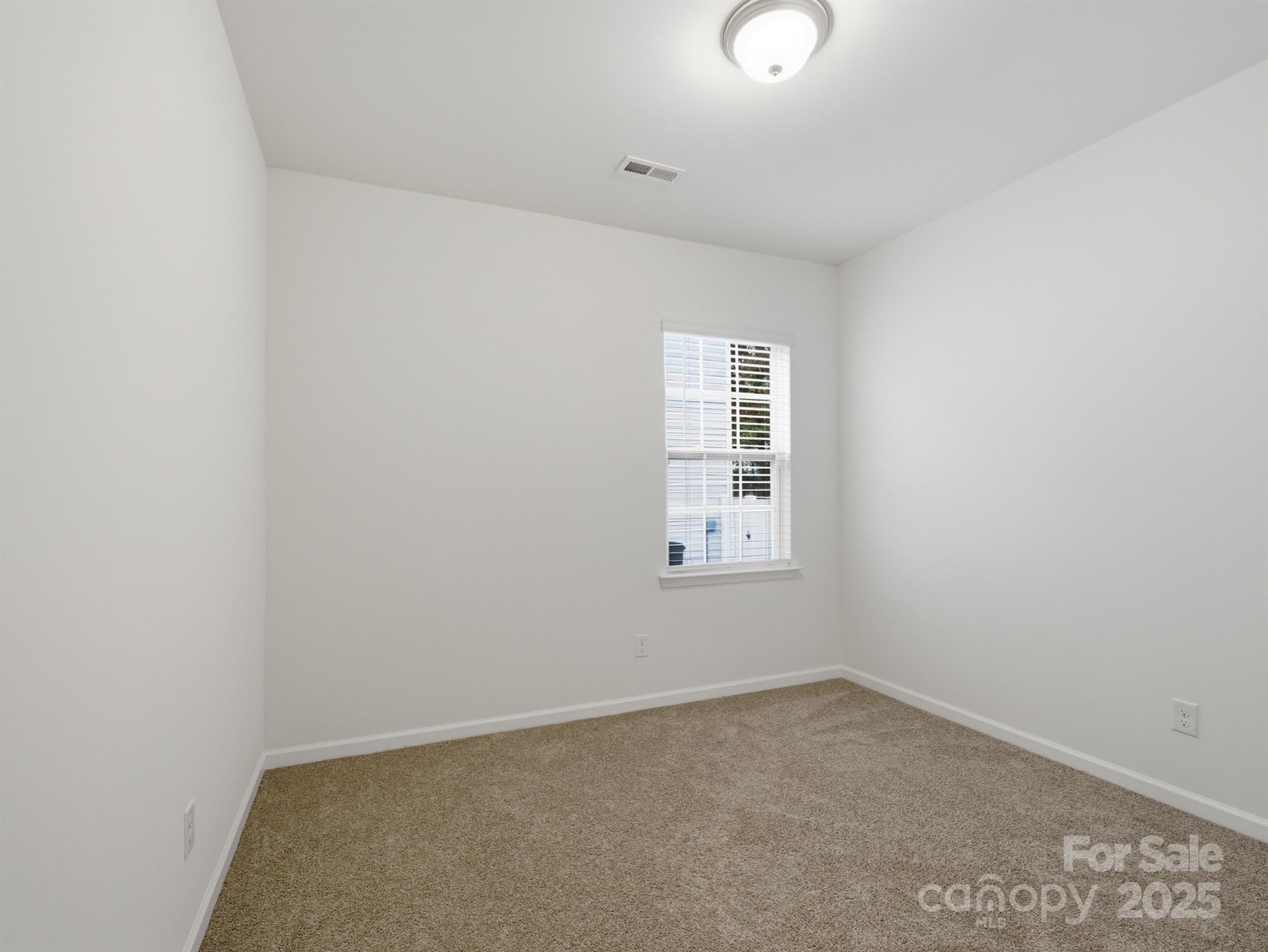 2212 Apple Glen Lane Charlotte, NC 28269 - Photo 21 of 32 an empty room with windows