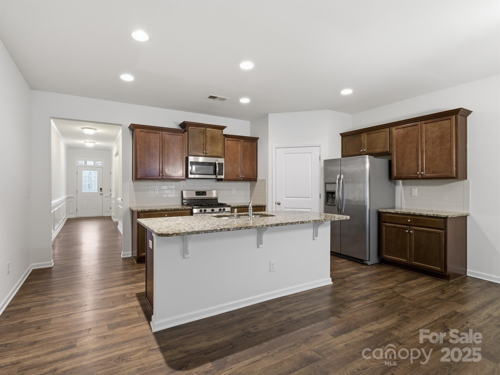 2212 Apple Glen Lane Charlotte, NC 28269 - Photo 3 of 32 a kitchen with stainless steel appliances granite countertop a sink stove and refrigerator