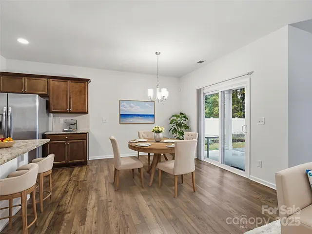 a dining room with furniture a window and wooden floor
