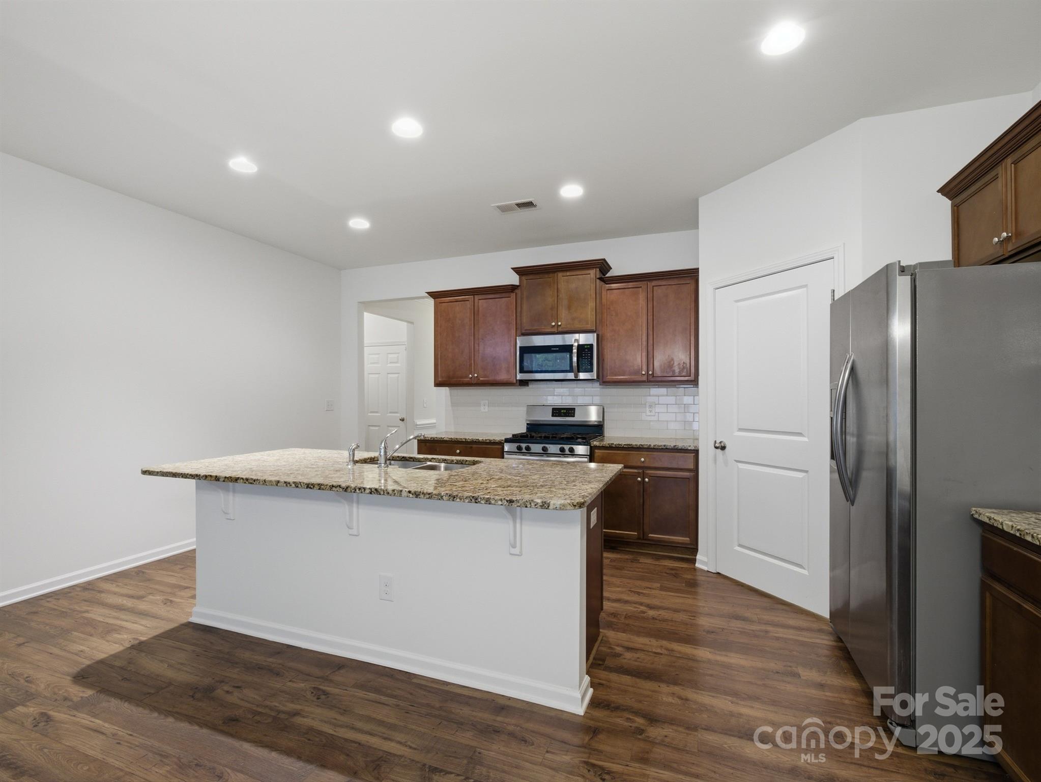 2212 Apple Glen Lane Charlotte, NC 28269 - Photo 5 of 32 a kitchen with granite countertop a refrigerator stove top oven and sink