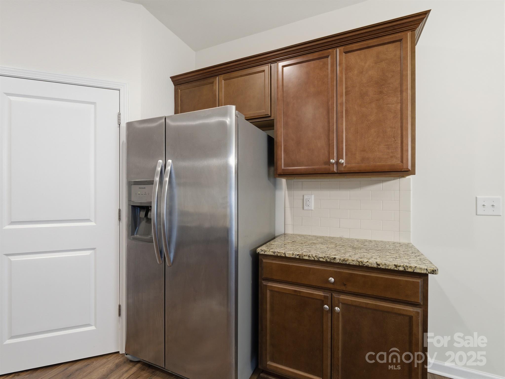 2212 Apple Glen Lane Charlotte, NC 28269 - Photo 9 of 32 a kitchen with a refrigerator and cabinets