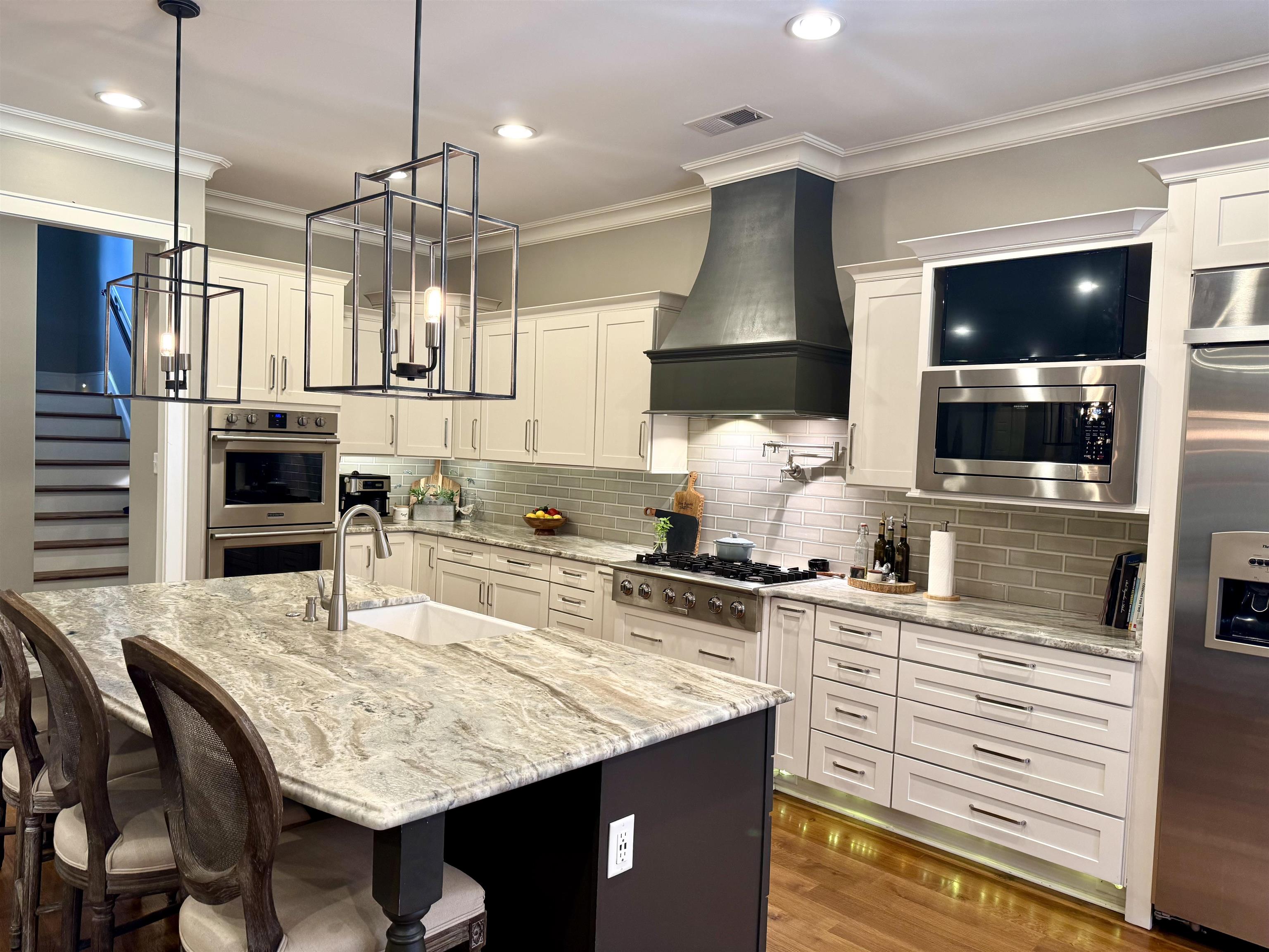 10879 Latting Road Eads, TN 38028 - Photo 15 of 40 a kitchen with stainless steel appliances kitchen island granite countertop a stove a sink and a microwave