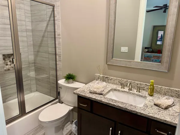 a bathroom with a sink vanity and a mirror