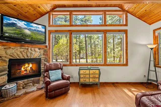 a living room with furniture a flat screen tv and a fireplace