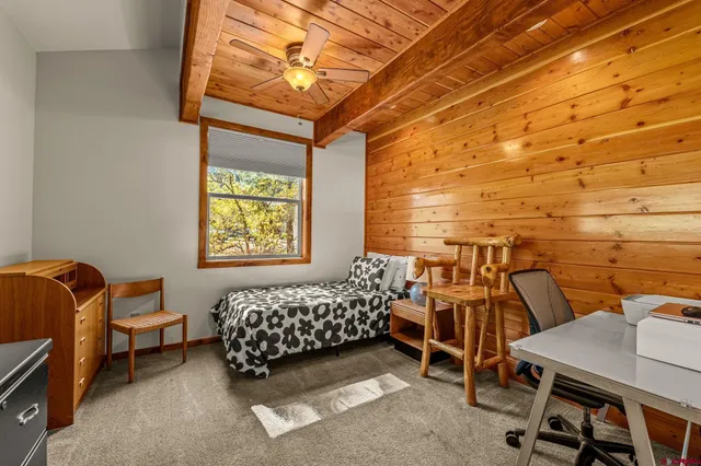 a bedroom with a bed and a desk