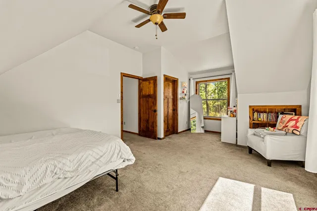 a spacious bedroom with a bed and a window