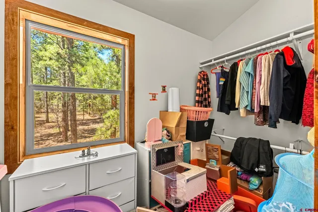 a living room with furniture a flat screen tv and a window