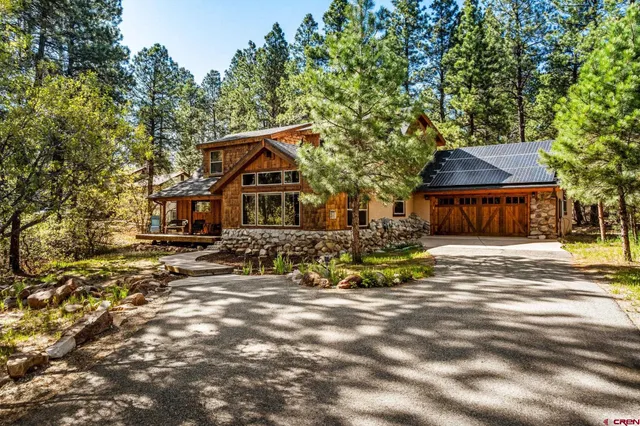 a view of a house with backyard tub and wooden furniture